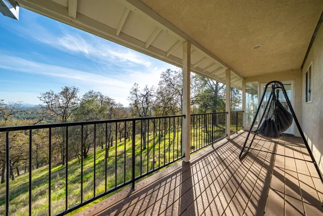 a view of a house with a yard and potted plants