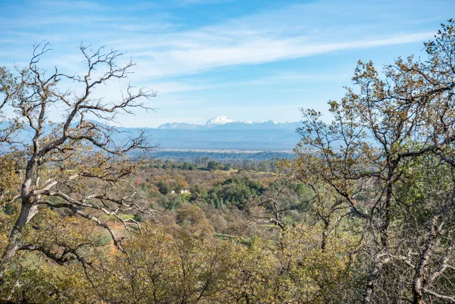 an aerial view of a house with a yard swimming pool and mountain view