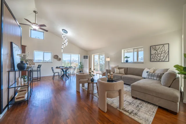 a living room with lots of furniture and wooden floor