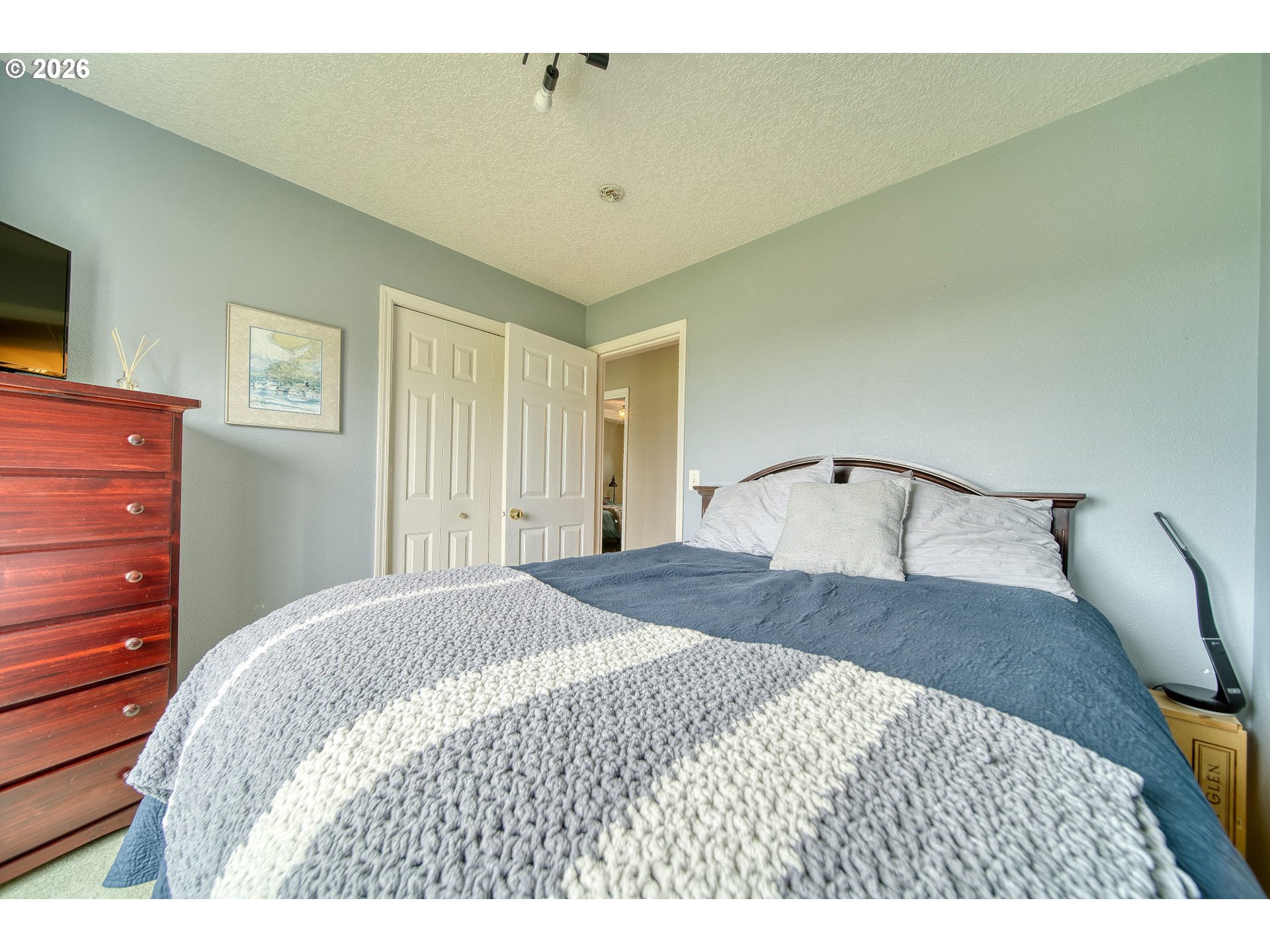 59016 Timberline Avenue St. Helens, OR 97051 - Photo 22 of 36 a bedroom with a bed and a flat screen tv