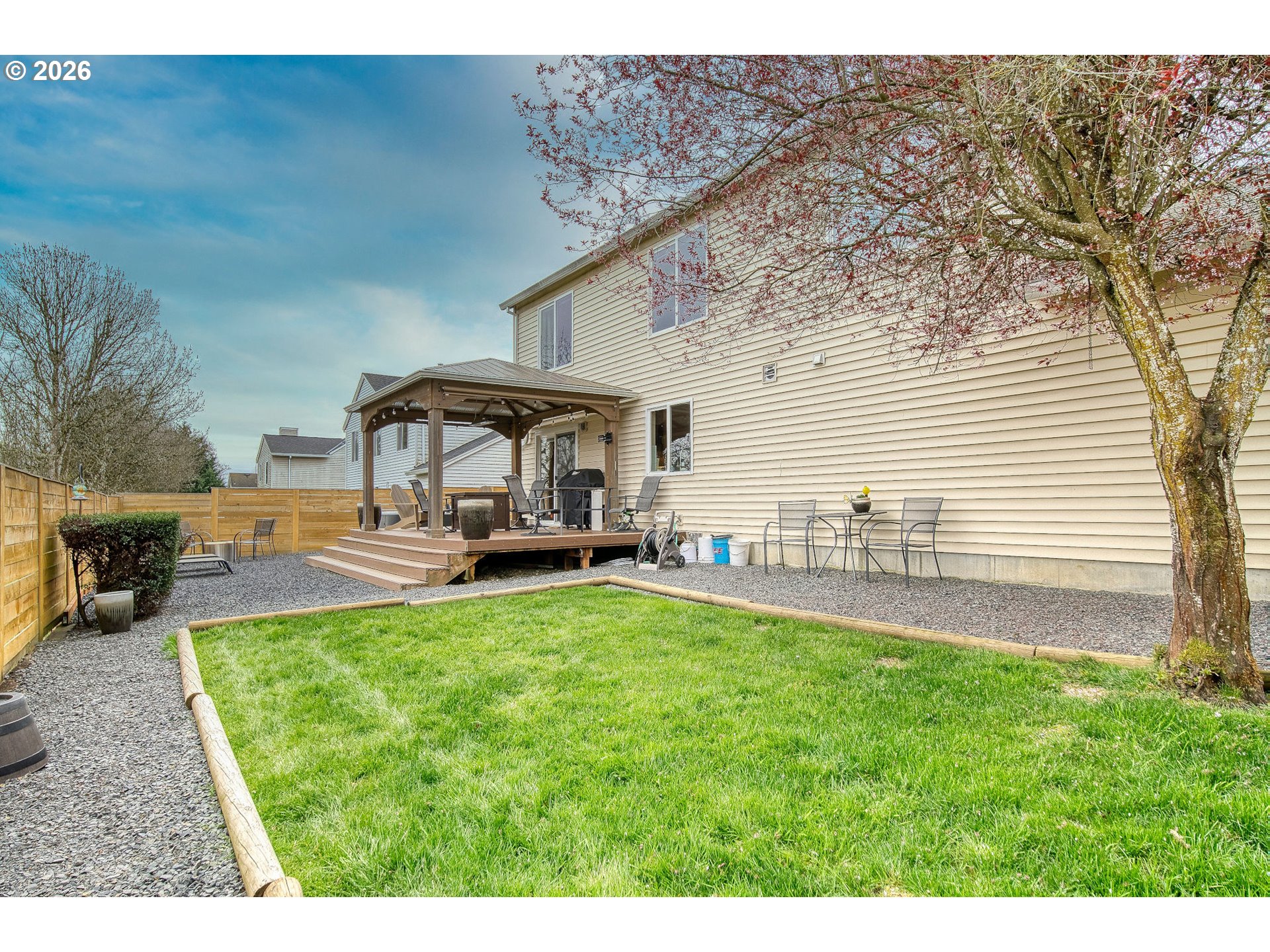 59016 Timberline Avenue St. Helens, OR 97051 - Photo 33 of 36 a view of a patio with table and chairs under an umbrella