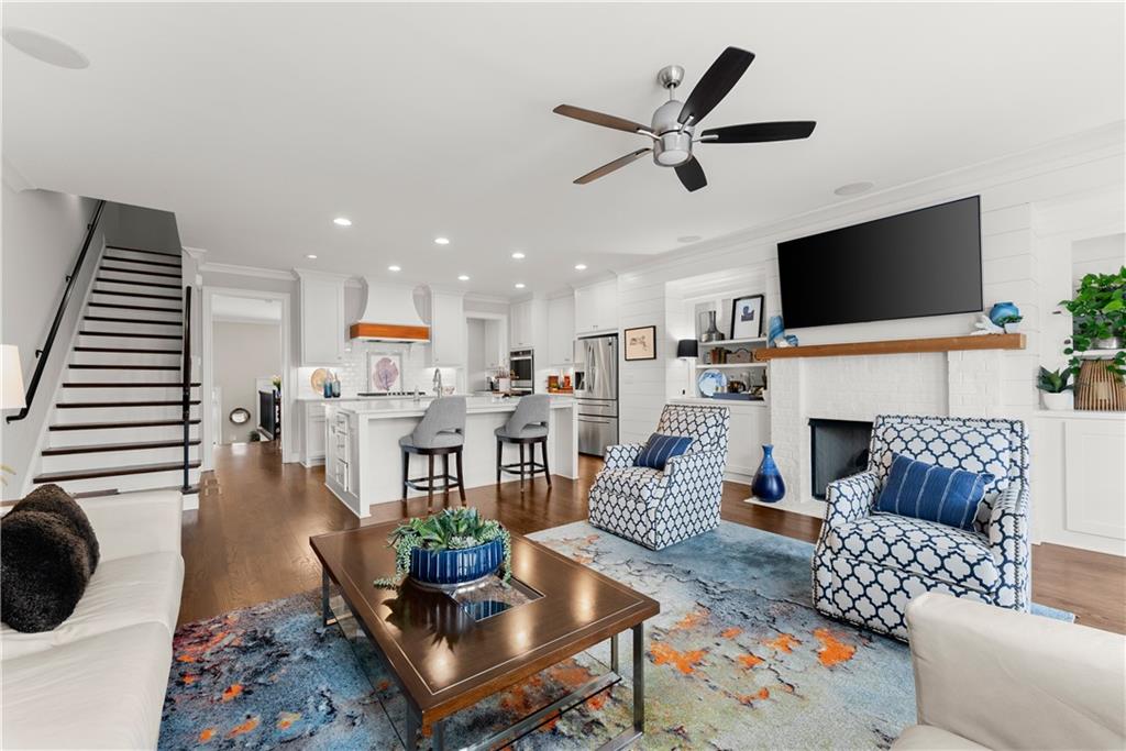 3206 Ridge Towne Place Duluth, GA 30096 - Photo 2 of 42 a living room with furniture a fireplace and a flat screen tv