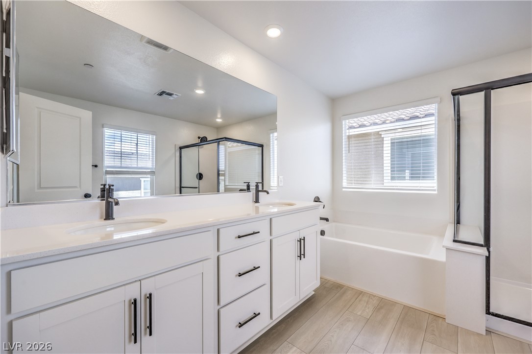 3782 Alla Rocca Avenue Henderson, NV 89044 - Photo 24 of 55 This spacious bathroom offers a double vanity, large mirror, and ample natural light for a bright start to your day.