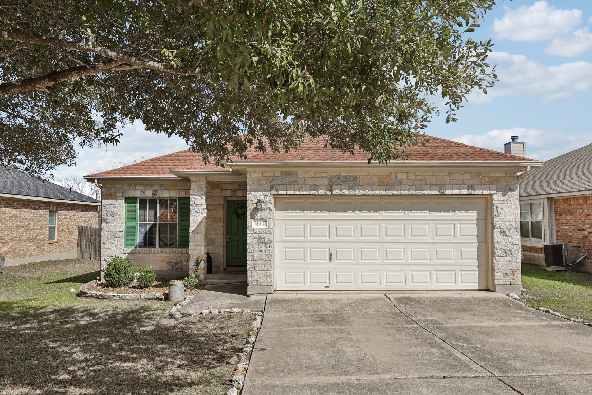 a front view of a house with a yard and garage