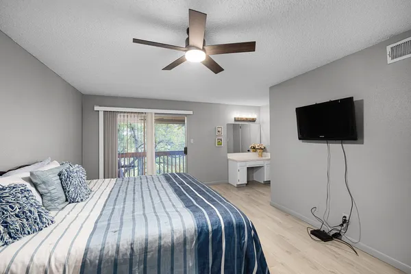 a spacious bedroom with a bed and a chandelier