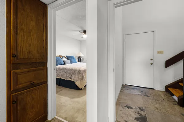 a bedroom with a bed and a chandelier