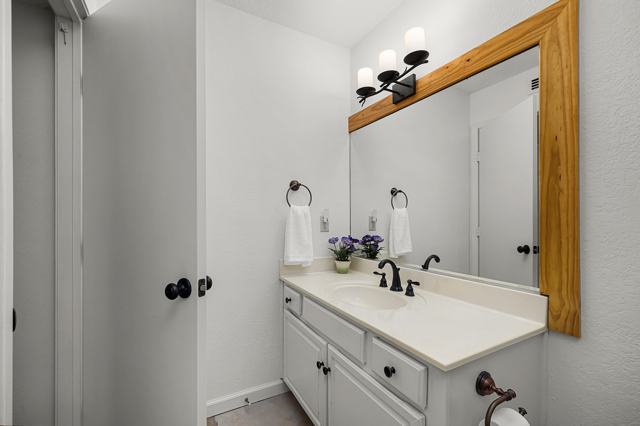 229 Comanche Lane Point Venture, TX 78645 - Photo 33 of 38 a bathroom with a sink vanity and a mirror