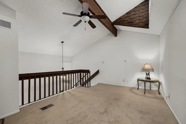 a living room with furniture and a ceiling fan
