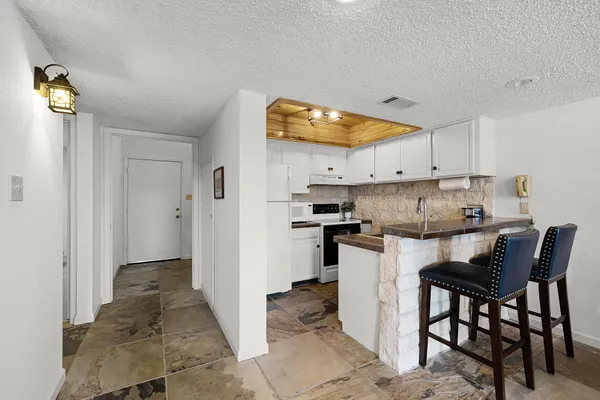 a kitchen with a refrigerator and a stove