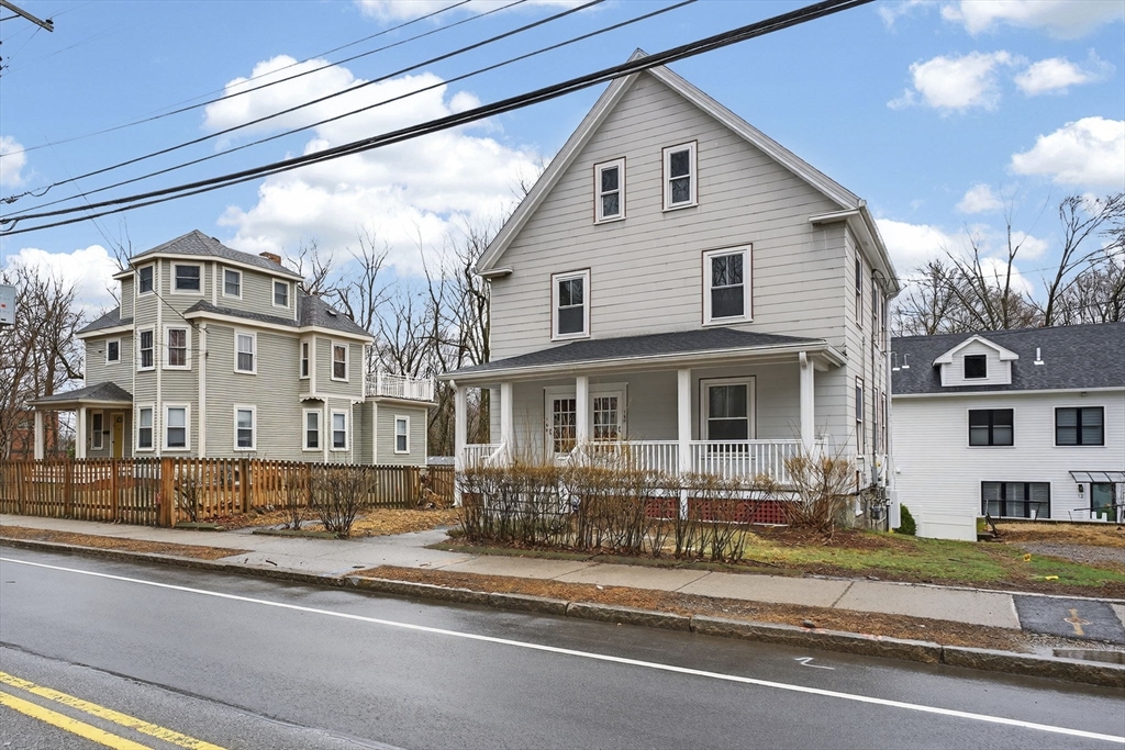 168 Elliot Street, Unit 1 Newton, MA 02464 - Photo 15 of 15 a front view of residential houses with yard