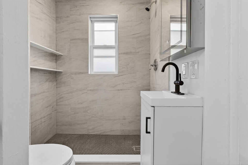 168 Elliot Street, Unit 1 Newton, MA 02464 - Photo 5 of 15 a bathroom with a toilet sink and shower