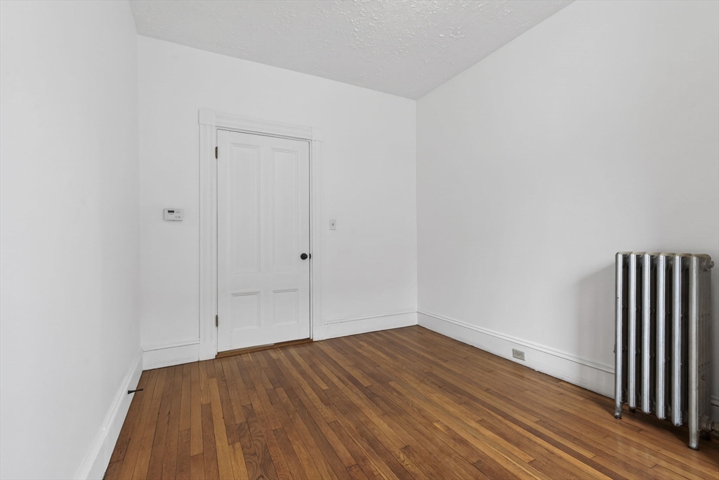 168 Elliot Street, Unit 1 Newton, MA 02464 - Photo 10 of 15 a view of empty room with wooden floor