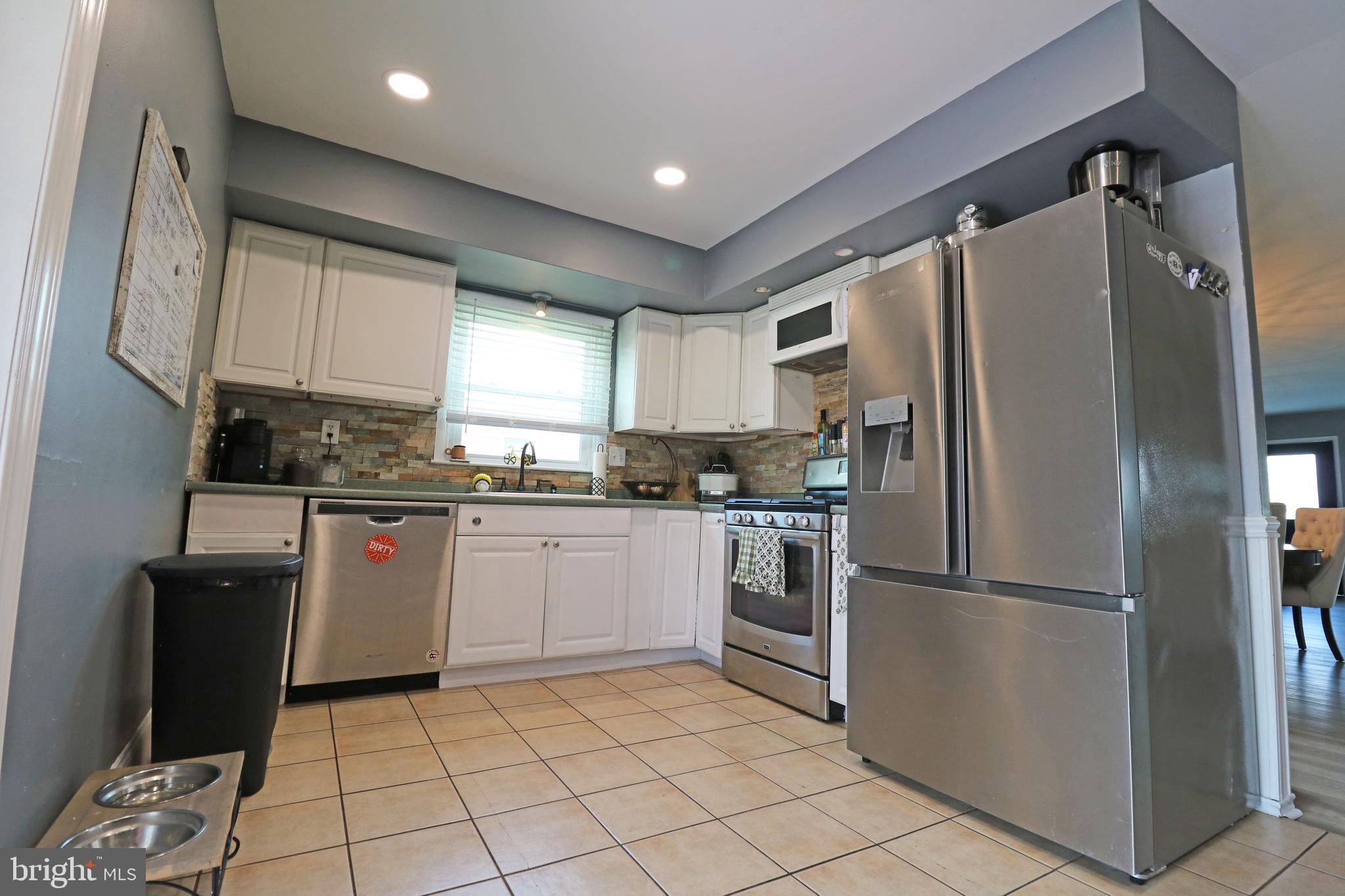 212 Riverview Avenue Ridley Park, PA 19078 - Photo 11 of 45 a kitchen with stainless steel appliances granite countertop a refrigerator sink and stove