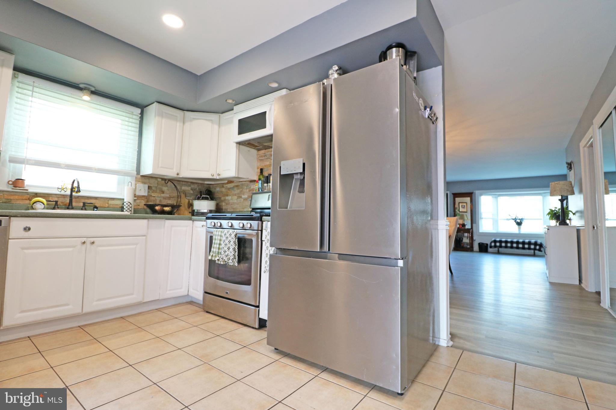212 Riverview Avenue Ridley Park, PA 19078 - Photo 12 of 45 a kitchen with stainless steel appliances a refrigerator sink and cabinets