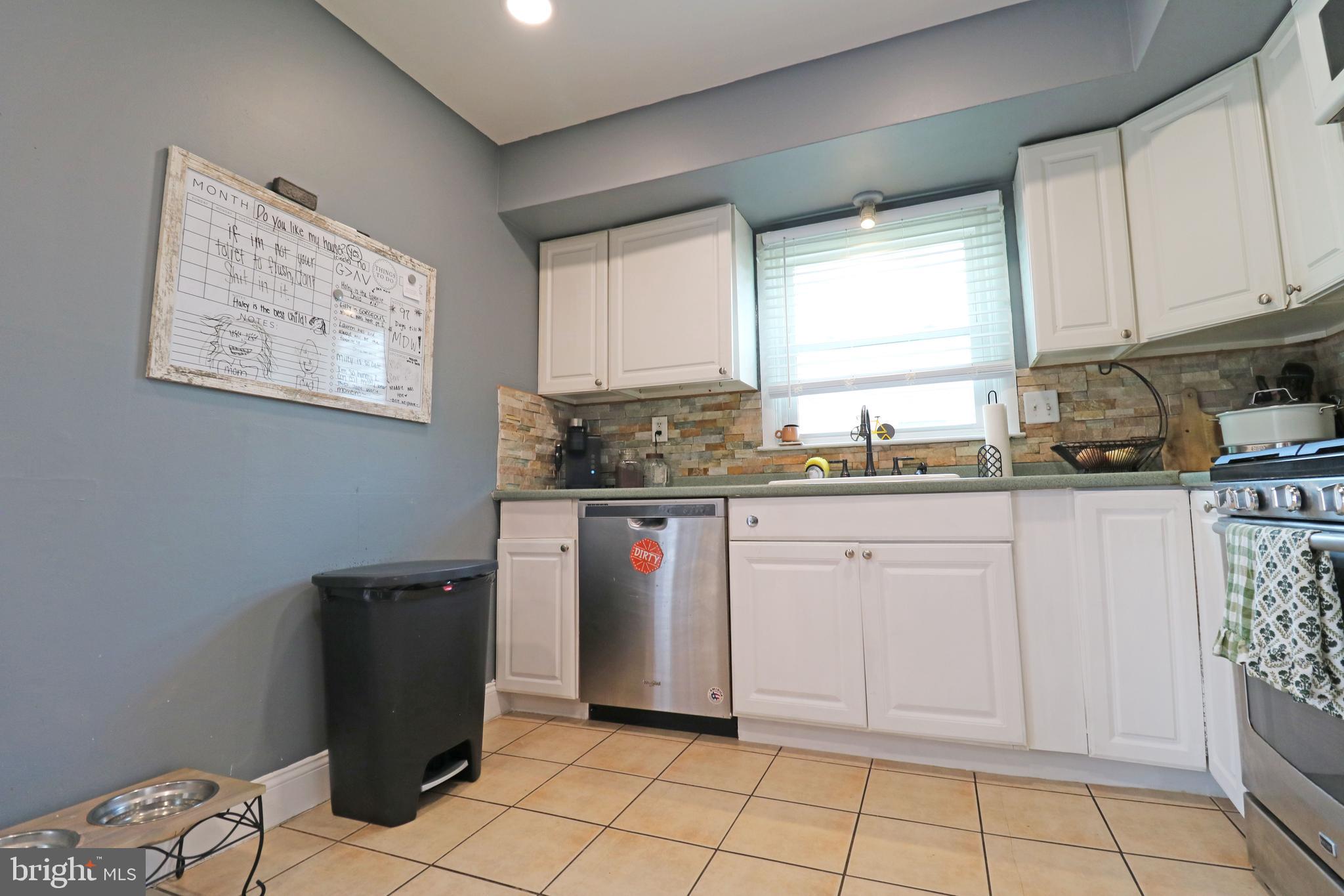 212 Riverview Avenue Ridley Park, PA 19078 - Photo 13 of 45 a kitchen with stainless steel appliances granite countertop a refrigerator sink and cabinets