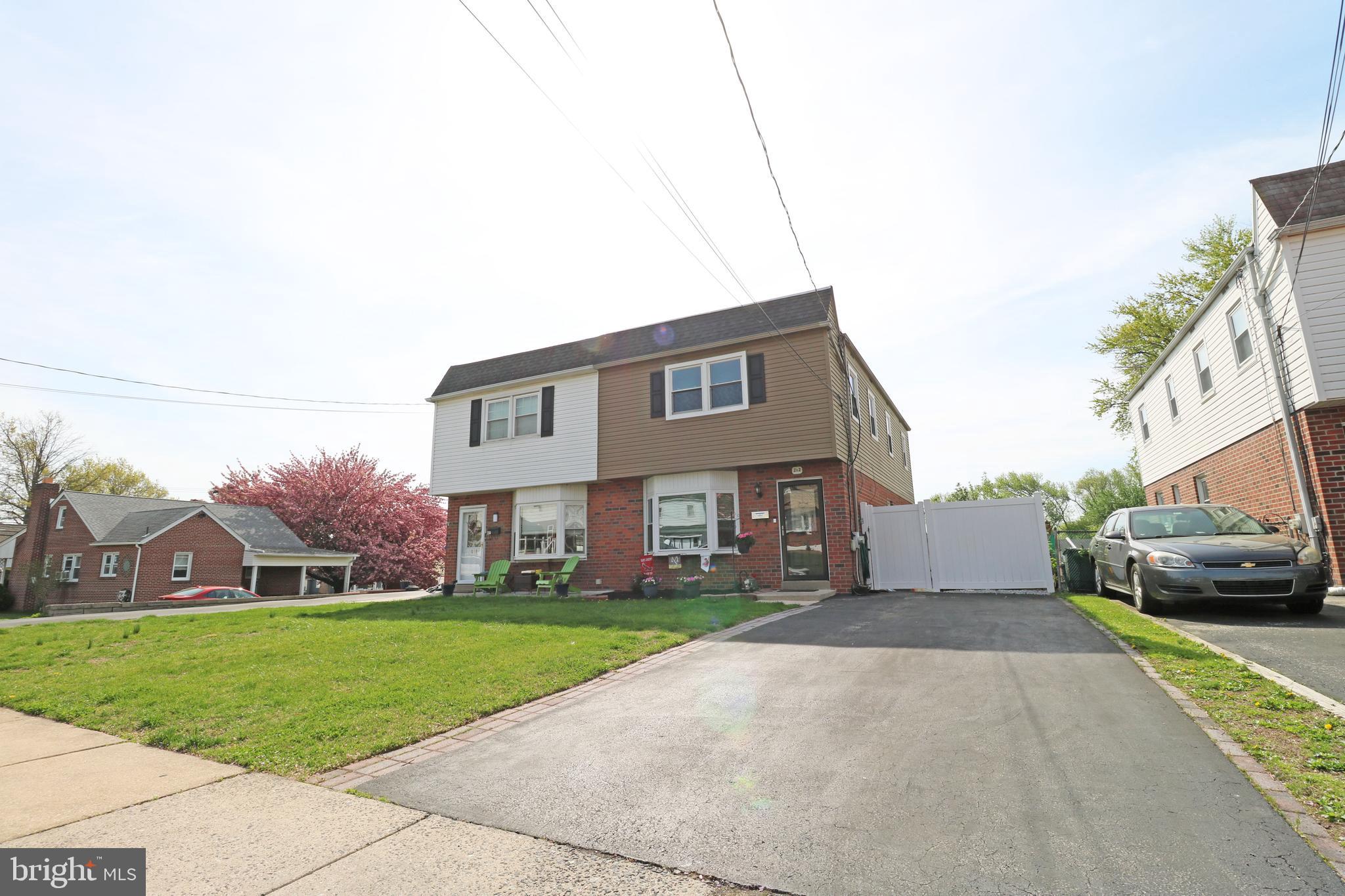 212 Riverview Avenue Ridley Park, PA 19078 - Photo 2 of 45 a front view of a house with a garden and plants