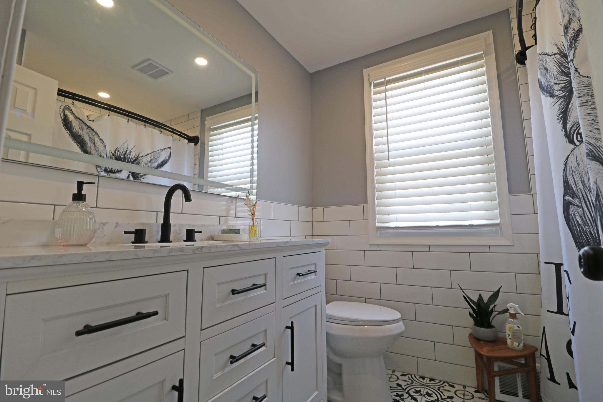 212 Riverview Avenue Ridley Park, PA 19078 - Photo 25 of 45 a bathroom with a granite countertop sink mirror vanity and toilet