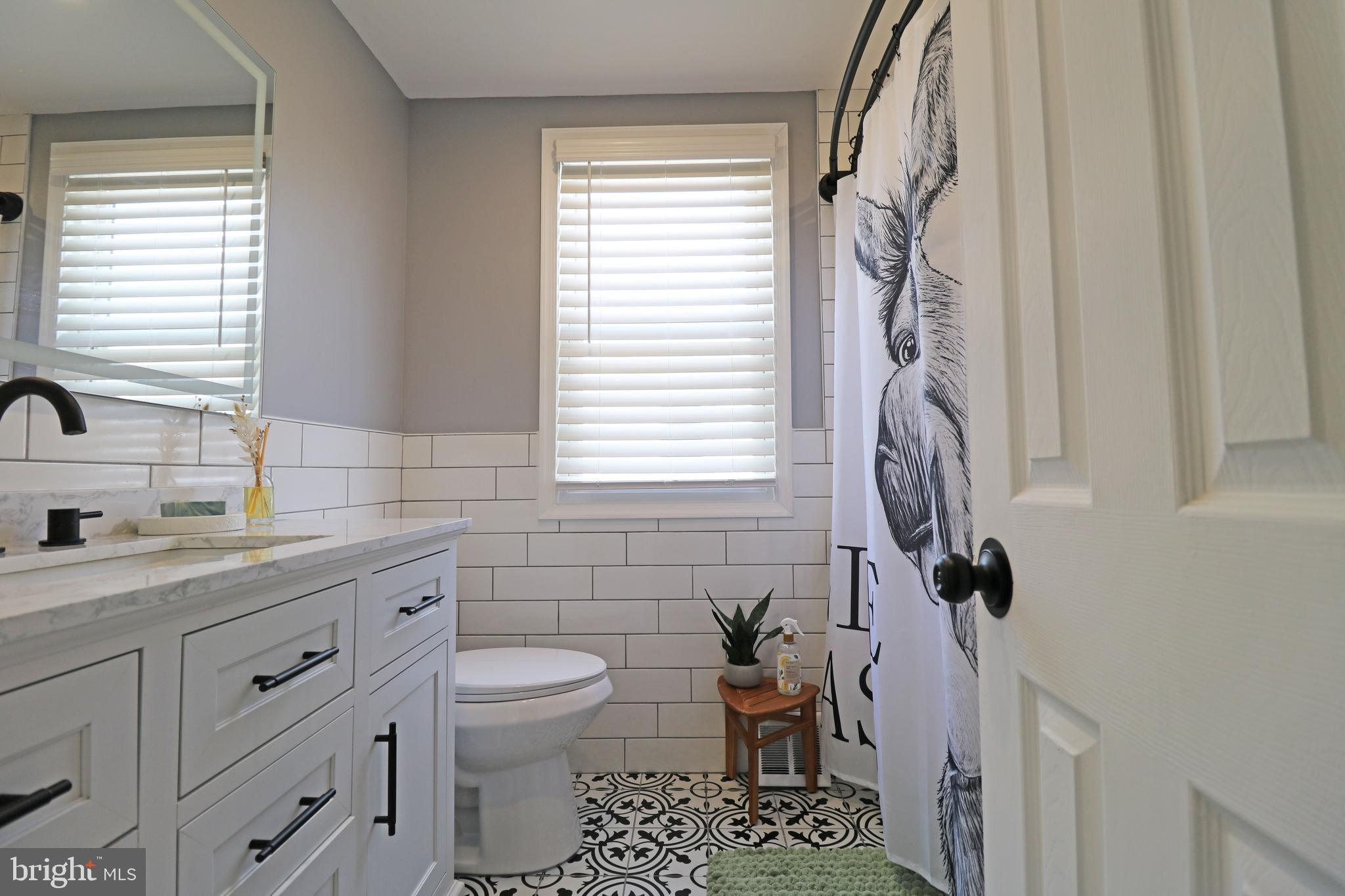 212 Riverview Avenue Ridley Park, PA 19078 - Photo 26 of 45 a bathroom with a granite countertop sink a toilet and a mirror