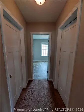 a bathroom with a granite countertop double vanity sink and a mirror