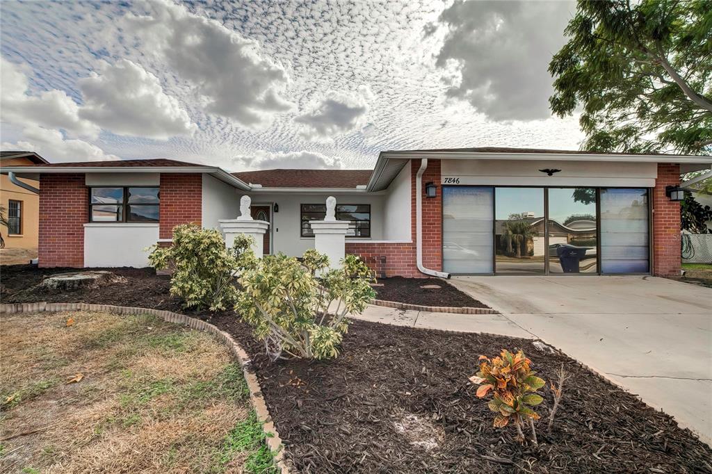 7846 Bahama Avenue Port Richey, FL 34668 - Photo 1 of 1 front view of a house with a yard