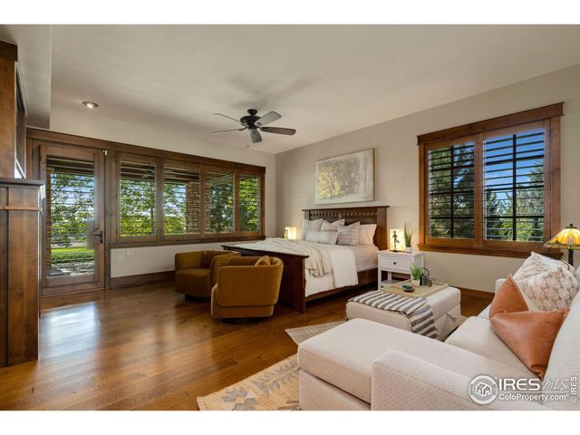 a living room with furniture floor to ceiling window and wooden floor