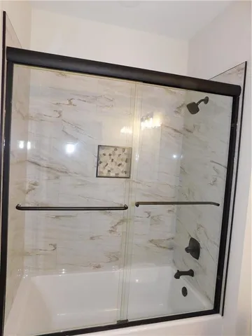 a bathroom with a glass shower door