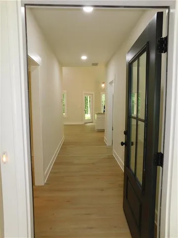a view of a hallway with wooden floor