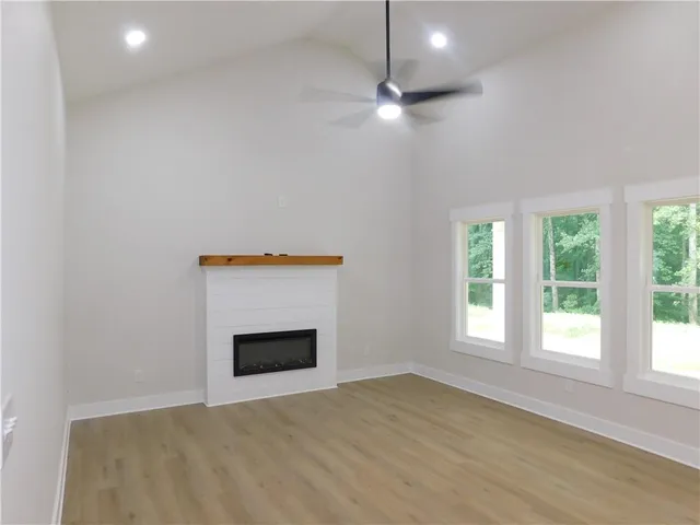 an empty room with a window and a fireplace