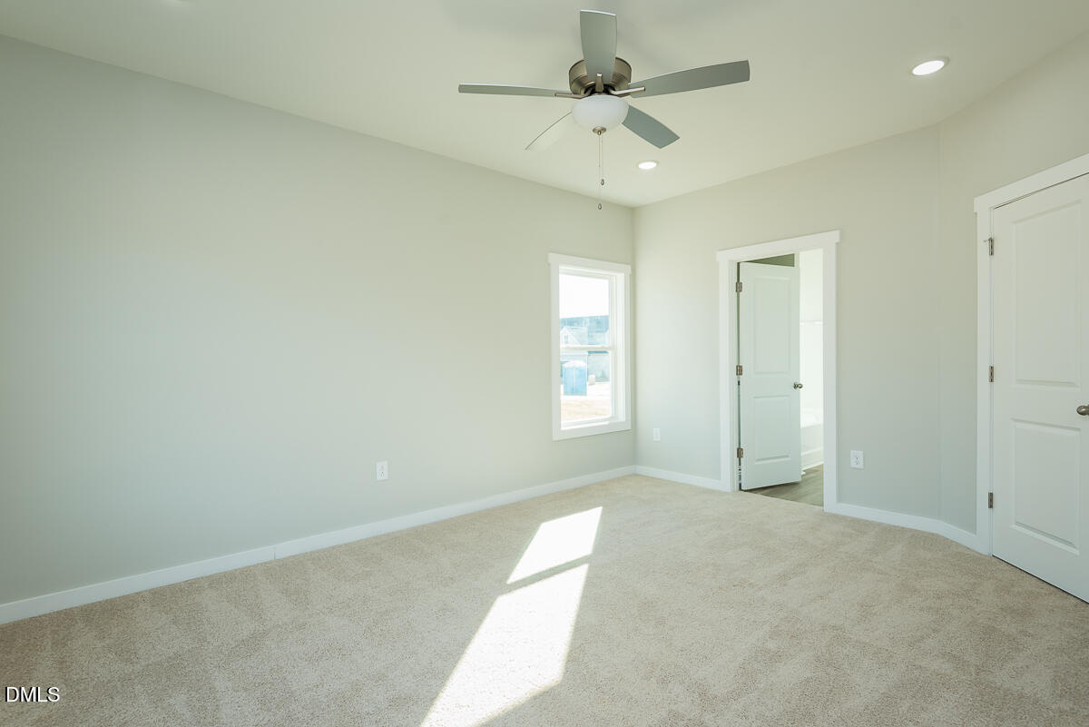 1193 Scarlet Oak Rd Spring Spring Hope, NC 27882 - Photo 15 of 25 an empty room with a ceiling fan and a window
