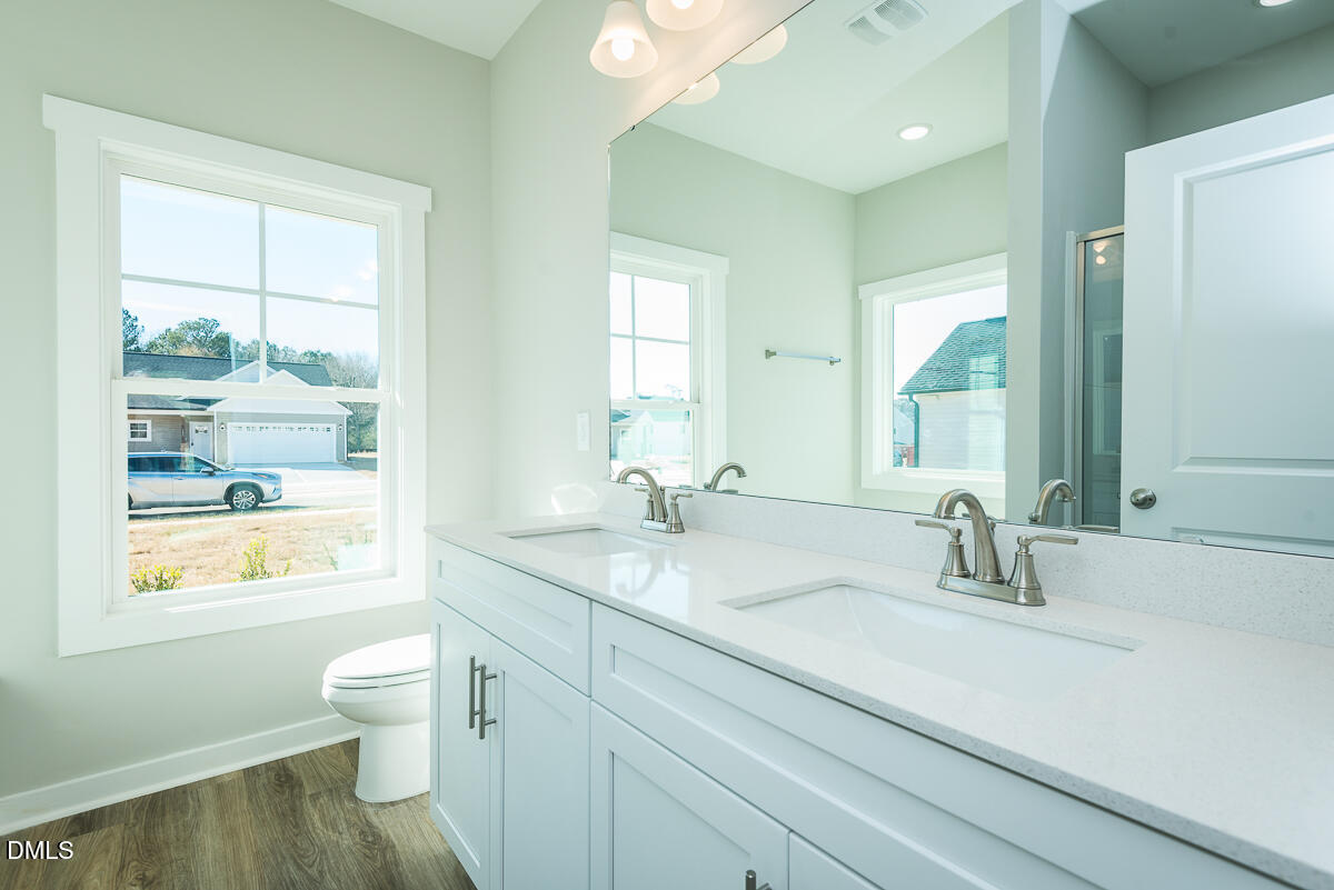 1193 Scarlet Oak Rd Spring Spring Hope, NC 27882 - Photo 16 of 25 a bathroom with a sink a toilet and a window