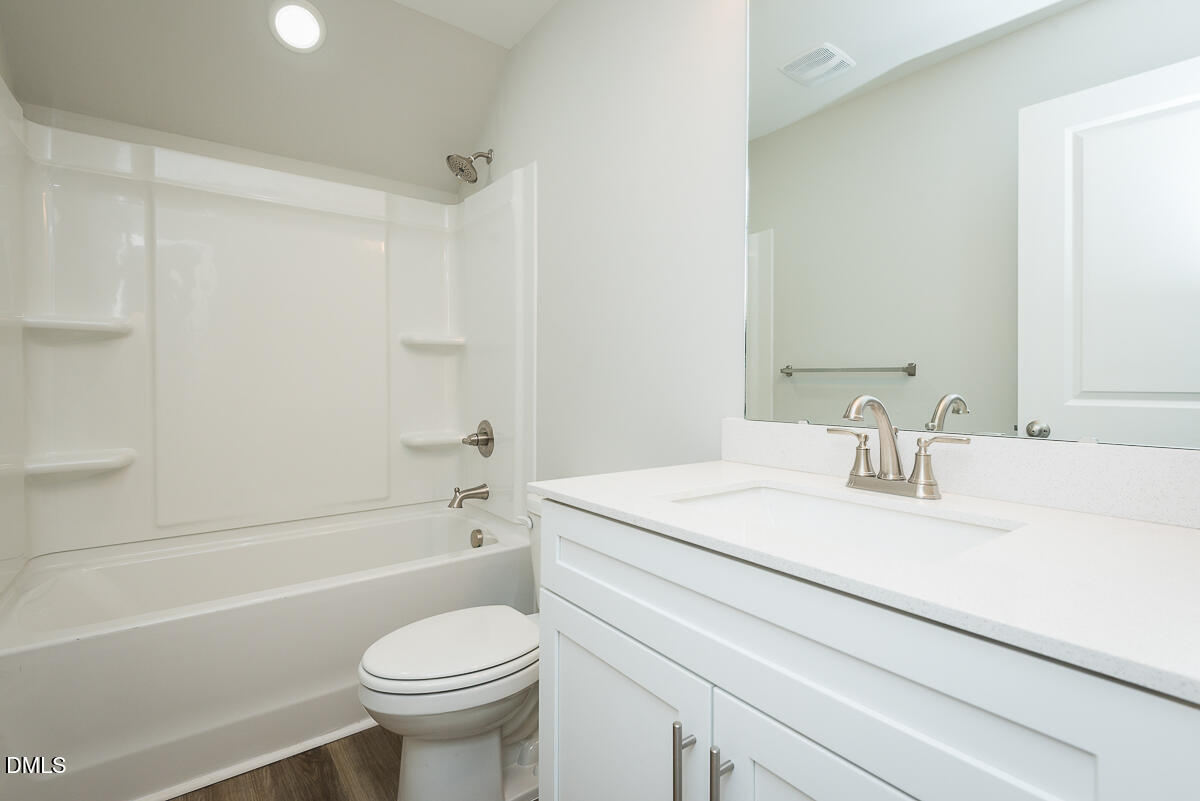 1193 Scarlet Oak Rd Spring Spring Hope, NC 27882 - Photo 21 of 25 a bathroom with a sink toilet vanity and shower