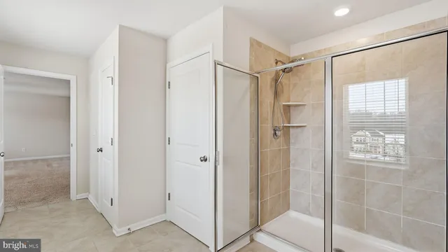a bathroom with a glass shower door
