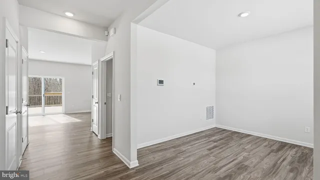 a view of a room with wooden floor