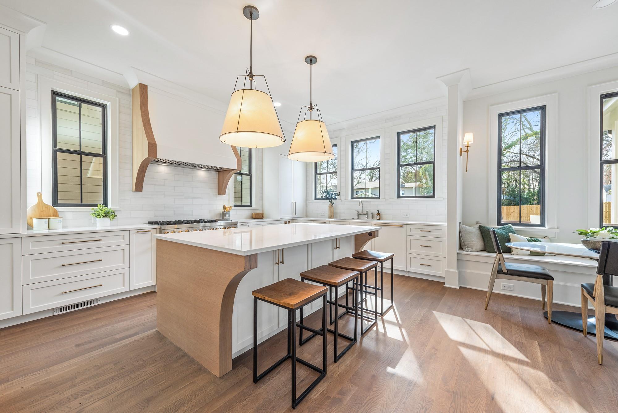 4324 Walker Road Charlotte, NC 28211 - Photo 2 of 44 a kitchen with center island table and chairs in it
