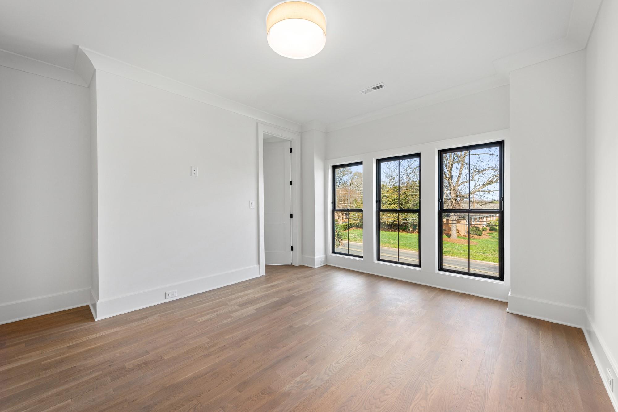 4324 Walker Road Charlotte, NC 28211 - Photo 41 of 44 a view of an empty room with wooden floor and a window