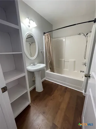 a bathroom with a sink a mirror and a shower