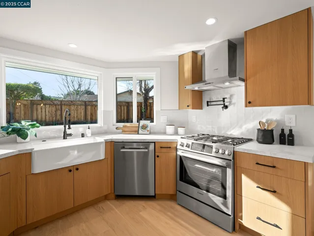 a view of a dining room with furniture wooden floor and a potted plant