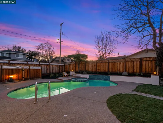 a swimming pool with outdoor seating and yard