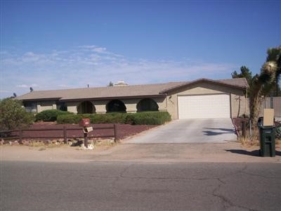 13951 Jicarilla Road Apple Valley, CA 92307 - Photo 1 of 1 a view of a patio with a table and chairs under an umbrella