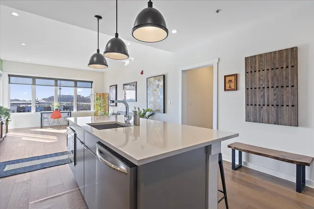 a kitchen with a table a sink and cabinets