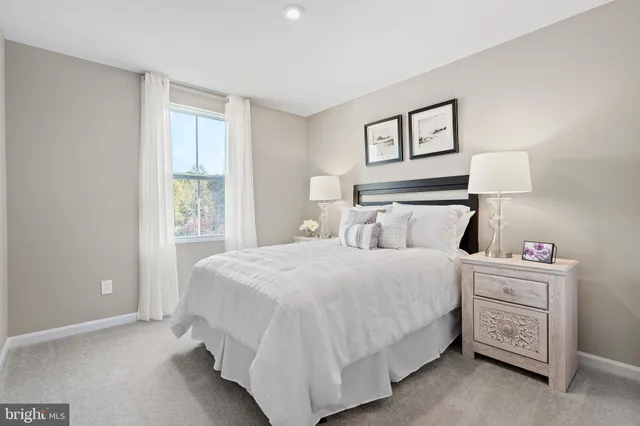 a bedroom with a bed and a night stand