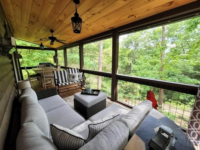 a living room with patio furniture and a floor to ceiling window