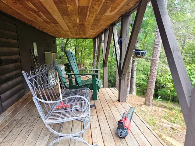 a view of a patio with a table chairs and a floor to ceiling window