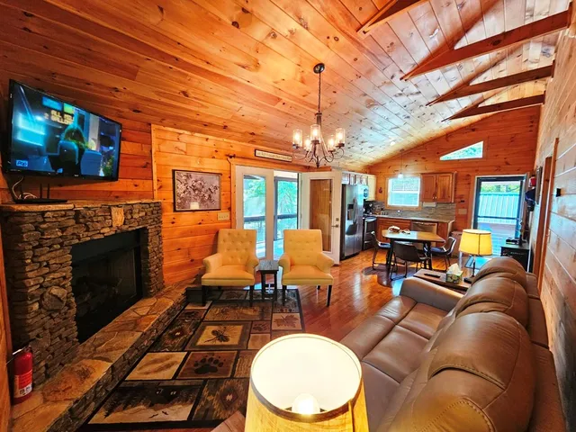 a living room with furniture a flat screen tv and a fireplace