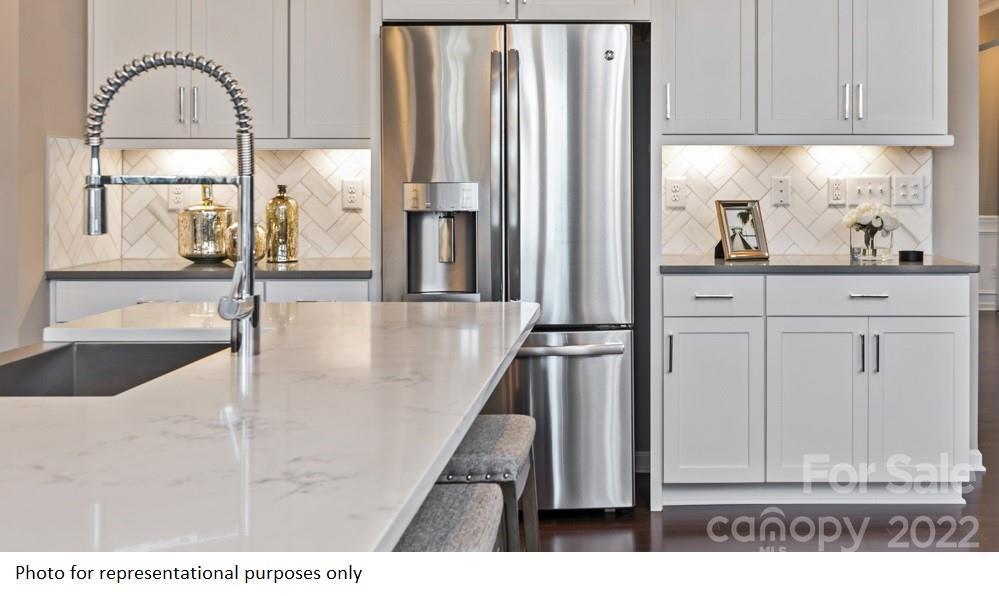 4039 Charlton Road, Unit 276 Fort Mill, SC 29715 - Photo 12 of 29 a kitchen with granite countertop a coffee maker on white cabinets and a sink