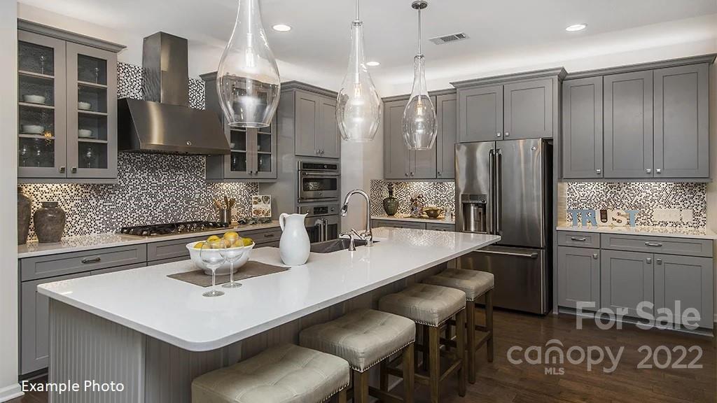 4039 Charlton Road, Unit 276 Fort Mill, SC 29715 - Photo 14 of 29 a kitchen with a sink a refrigerator and wooden cabinets