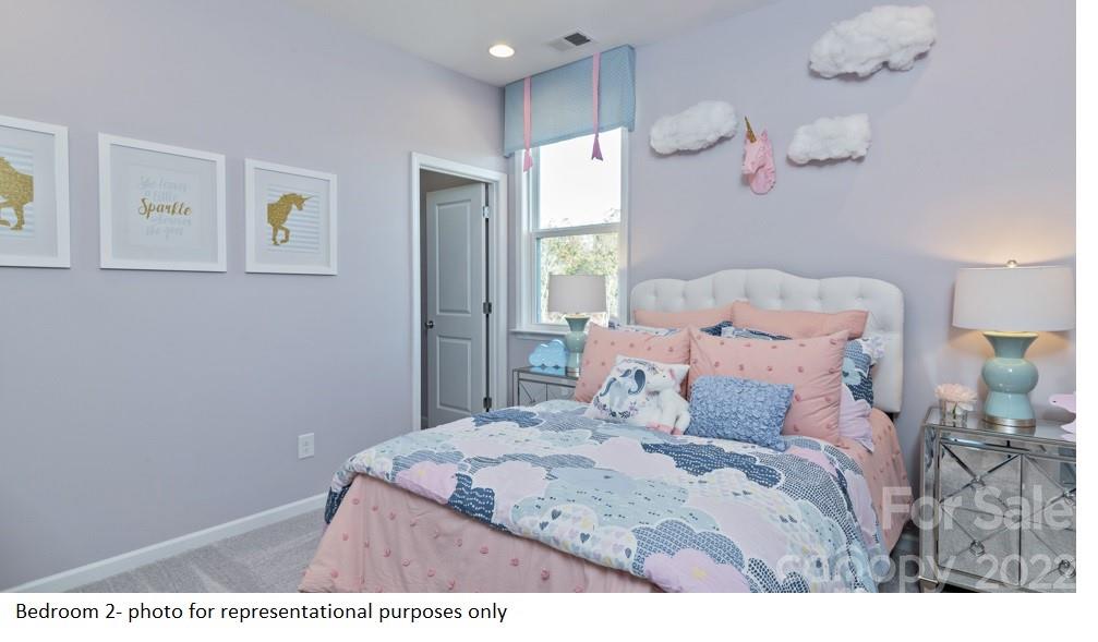 4039 Charlton Road, Unit 276 Fort Mill, SC 29715 - Photo 21 of 29 a bedroom with a bed and a table