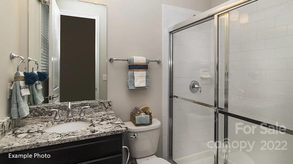 4039 Charlton Road, Unit 276 Fort Mill, SC 29715 - Photo 6 of 29 a bathroom with a granite countertop sink and a mirror