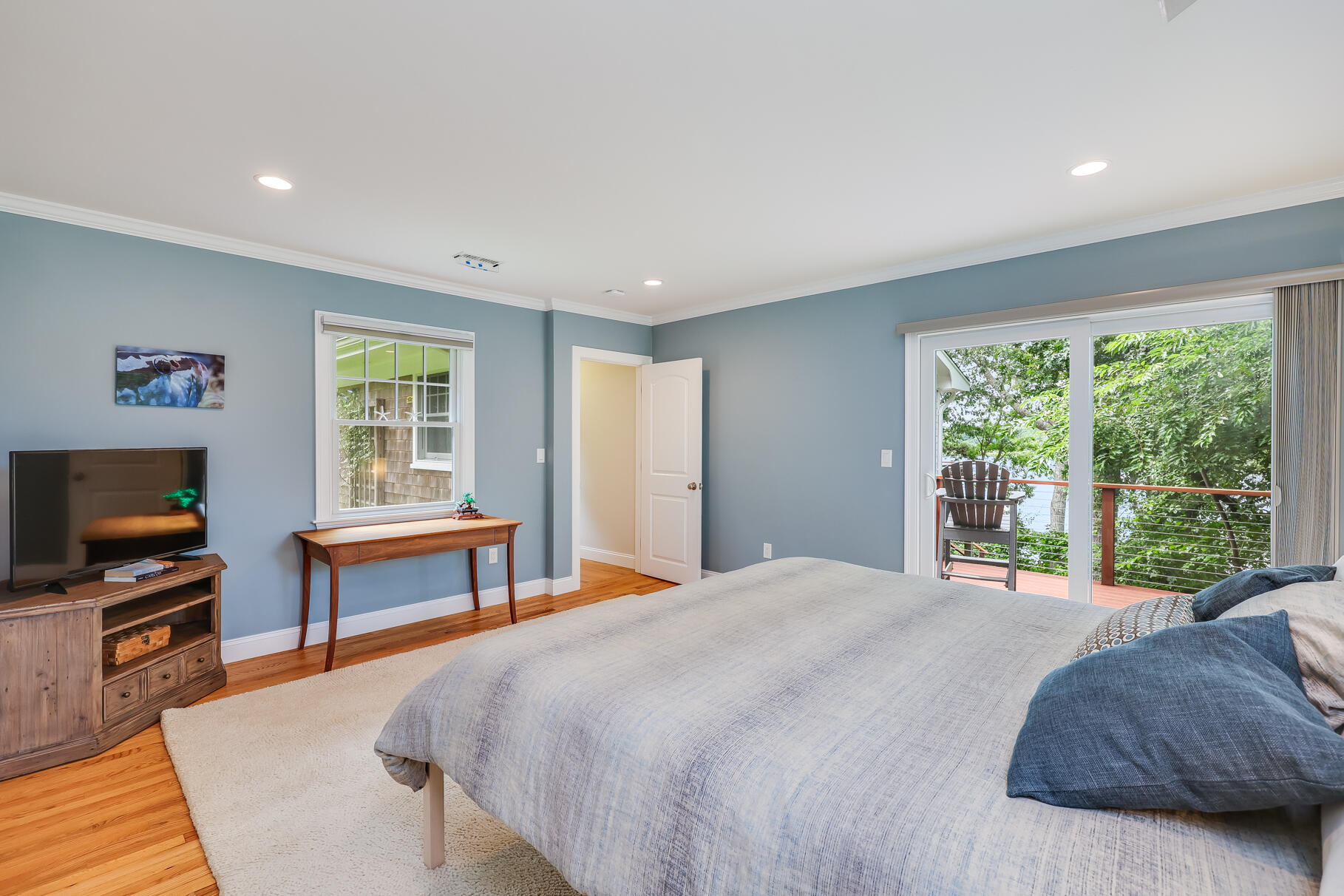 24 Bay Road Cotuit, MA 02635 - Photo 14 of 44 a bedroom with a bed and a flat screen tv