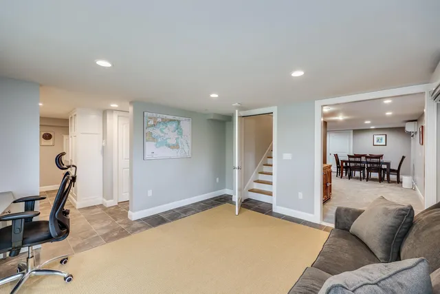 a living room with dining room and wooden floor